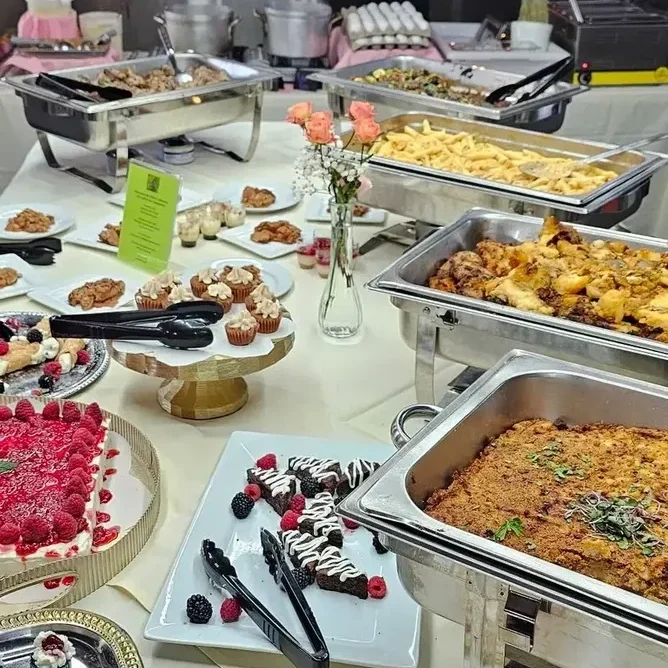 A buffet table filled with various dishes and desserts.